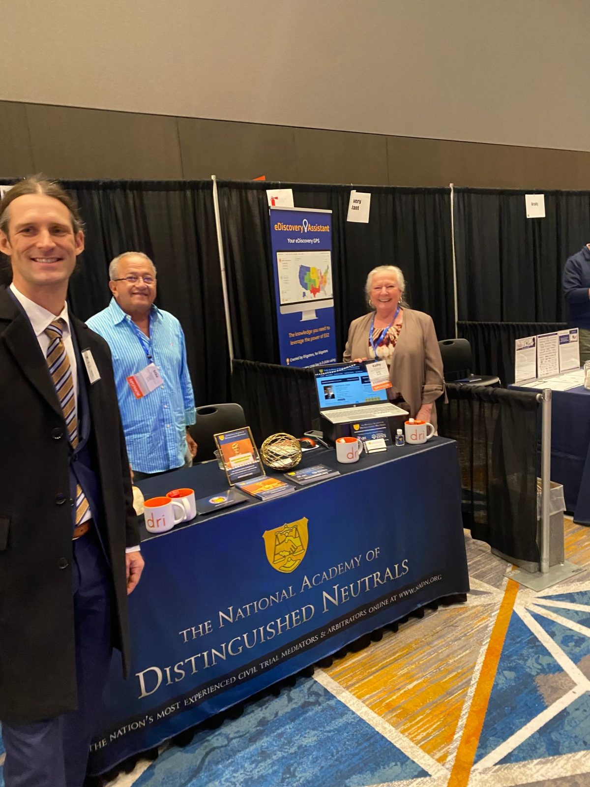 Reese Willson at the National Academy of Distinguished Neutrals booth in the DRI Annual Meeting exhibit hall