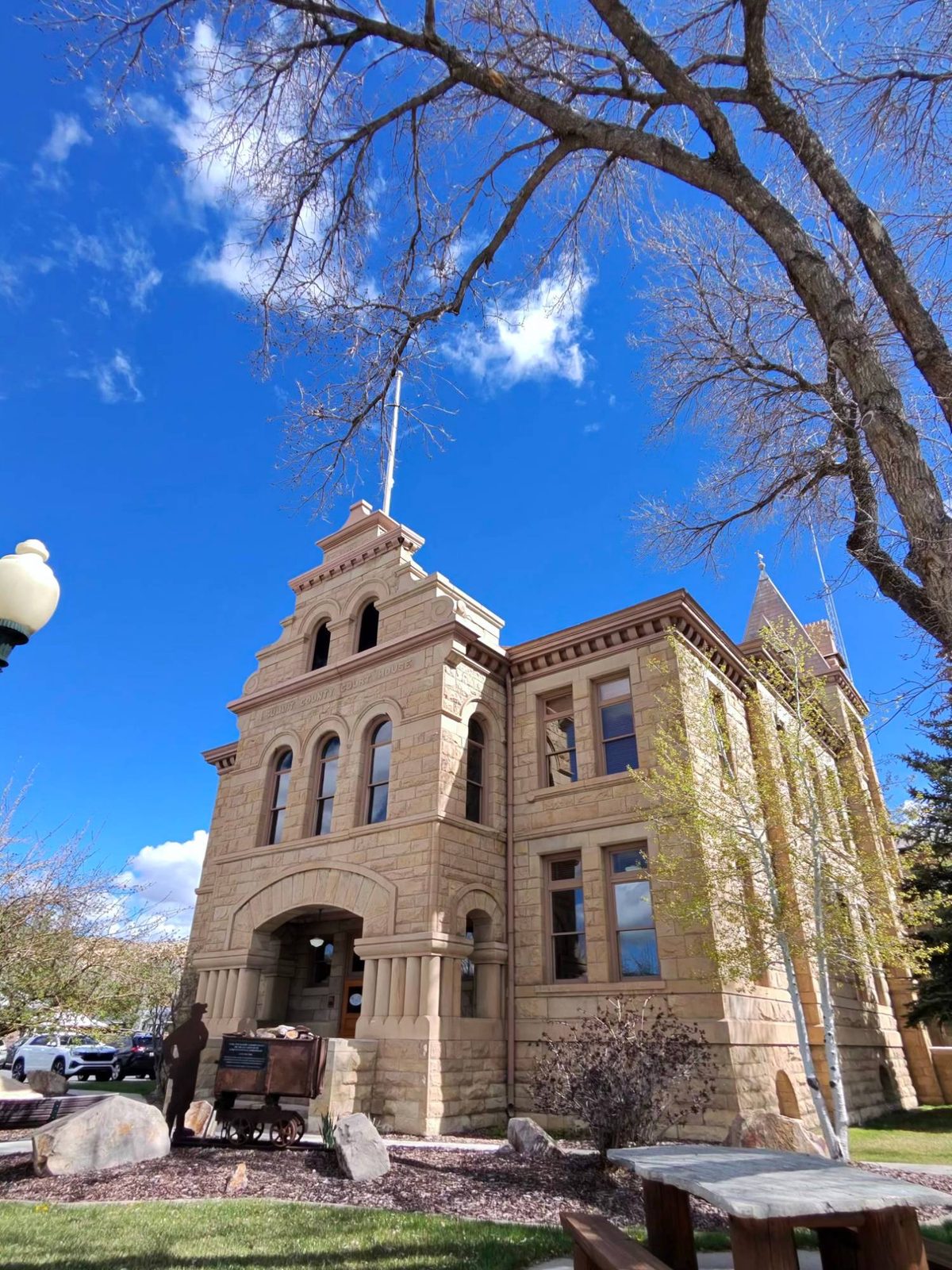 The historic Summit County Courthouse in Coalville, Utah, under a blue sky